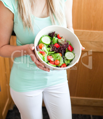 Beautiful woman showing a salad