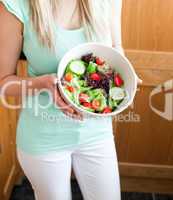 Beautiful woman showing a salad