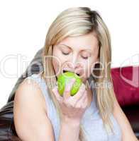 Cheerful woman eating an apple