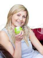 Joyful woman eating an apple