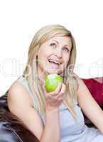 Smiling woman eating an apple