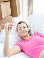 Joyful woman relaxing on a sofa with boxes