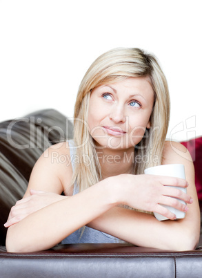 Pensive woman holding a cup of coffee