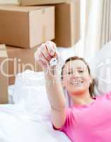 Lively woman relaxing on a sofa with boxes
