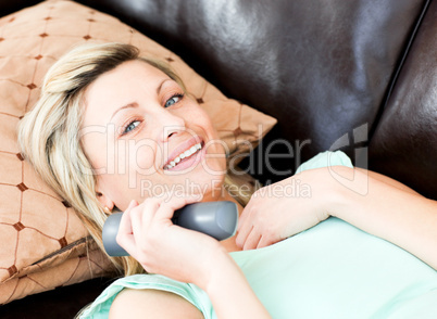 Happy woman using a remote