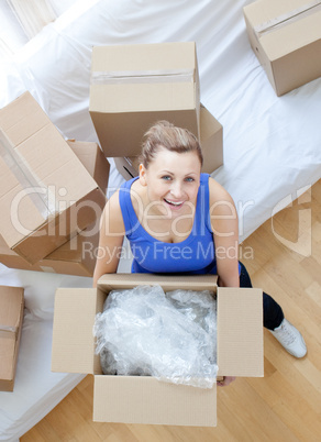 Smiling woman holding a box