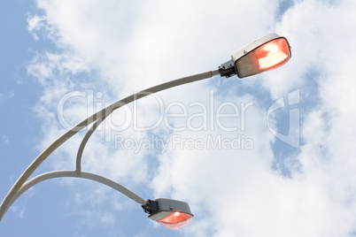 Shining street lamp over blue sky