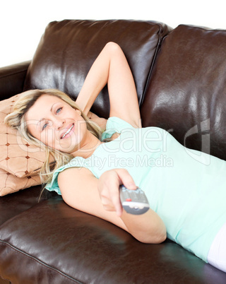 Relaxed woman using a remote