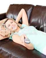 Relaxed woman using a remote