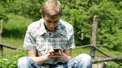 teenager types text on mobile.