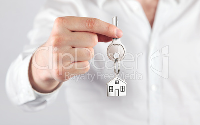 giving house key with a keychain house form