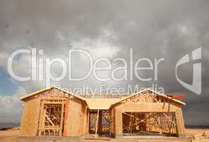 Abstract Home Construction Site and Ominous Clouds