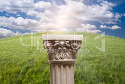 Ancient Replica Column Pillar Over Grass and Clouds