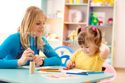 Teacher with child in preschool