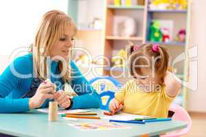 Teacher with child in preschool