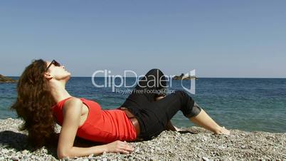 Woman lies near the sea