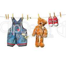 Children's clothes with teddy bear on clothesline