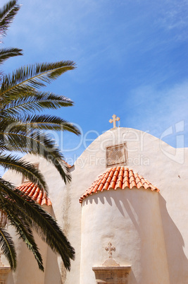 Orthodox Church behind palm tree fronds, Crete, Greece