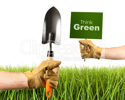 Hands holding garden trowel and sign
