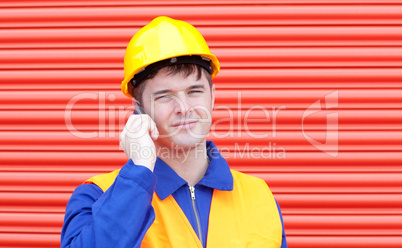 Serious male engineer talking on the phone
