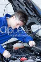 Concentrated man repairing a car