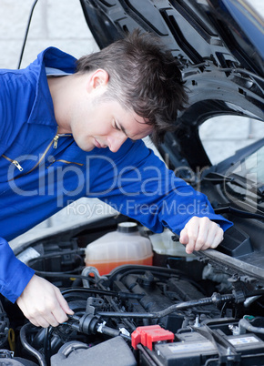 Self-assured man repairing a car