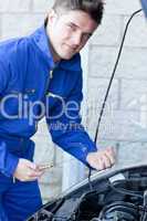 Confident man repairing a car