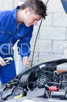 Handsome man repairing a car