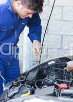 Attractive man repairing a car