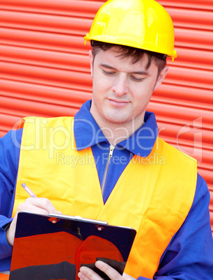 Mature male engineer writing his report