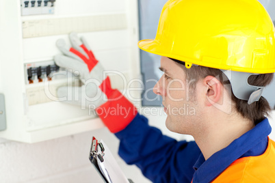 Caucasian electrician repairing a power plan