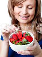 Caucasian woman eating strawberries