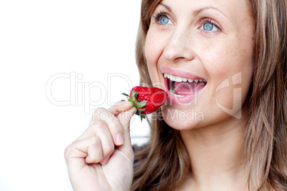 Young woman eating strawberries