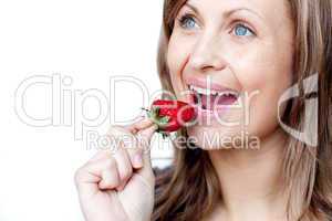 Young woman eating strawberries