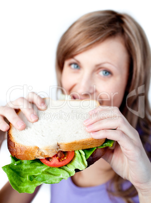 Smiling woman holding a sandwich