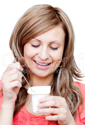 Radiant woman eating a yogurt