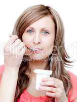 Attractive woman eating a yogurt