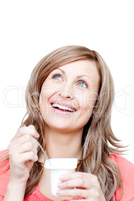 Cheerful woman eating a yogurt