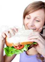 Caucasian woman holding a sandwich