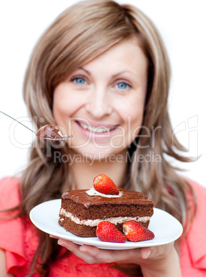 Cheerful woman eating a cake