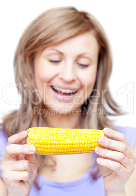 Smiling woman holding a corn