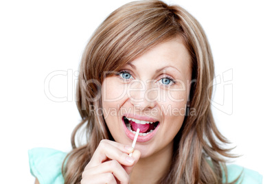 Joyful woman holding a lollipop