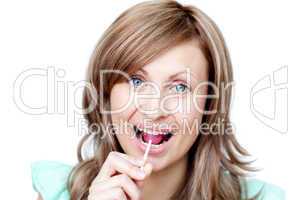 Joyful woman holding a lollipop
