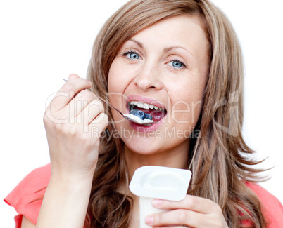 Lively woman eating a yogurt