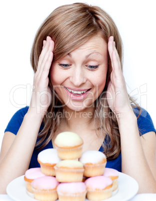 Astonished woman eating a cake