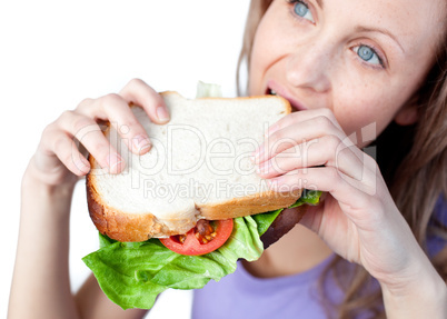 Hungry woman holding a sandwich