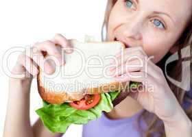 Hungry woman holding a sandwich