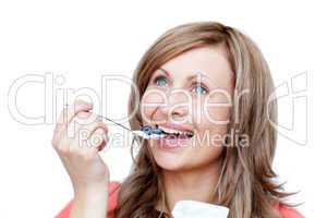 Cute woman eating a yogurt