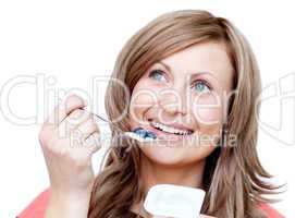 Happy woman eating a yogurt