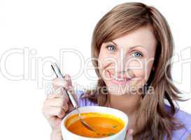 Joyful woman holding a soup bowl